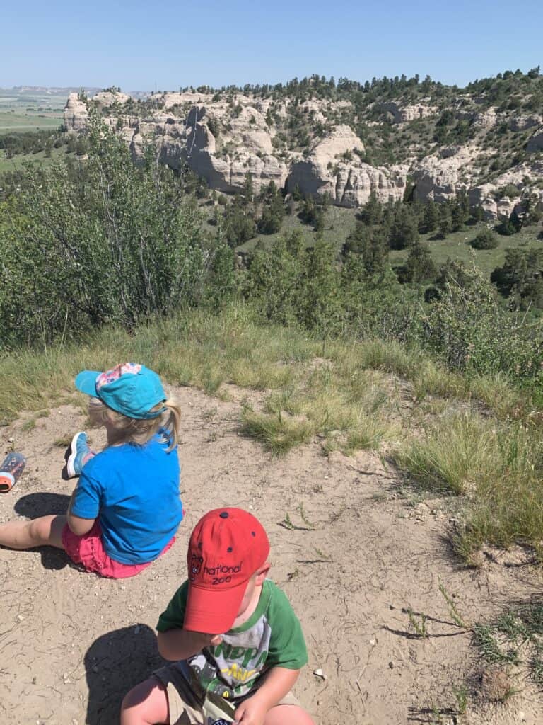Preschool children enjoying nature play outdoors during a family nature walk.
