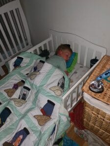 Young child sleeping in a toddler bed during quiet time for kids, showing how rest time can sometimes turn into a nap.